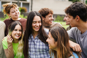Obraz na płótnie Canvas Young group of students having fun outdoor with school university campus on background - Back to school concept - Main focus on center girl face - UGC content