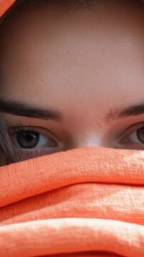 A close-up shot of a person with a towel covering their head, possibly after showering or swimming