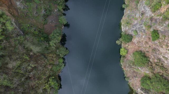 Menheniot, South Cornwall, England: DRONE VIEWS: A birds eye view of zip wires traversing a former quarry lake. The lake is a mile south-west of the village of Menheniot, a former mining area. 