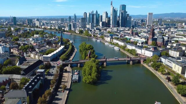 Aerial approach toward Frankfurt&rsquo;s Alte Br&uuml;cke and Main Island with Frankfurt Cathedral, historic city center and financial district skyline. Filmed September 25, 2026.