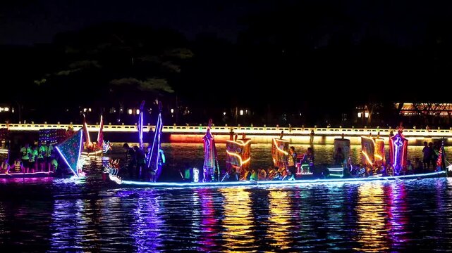 Illuminated Night Boat Parade with Colorful Lights on Water