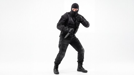 Obraz premium Dangerous criminal wearing black tactical gear and balaclava holding knife ready to attack on white background