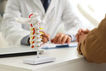 Spinal health and medical consultation, doctor explaining back pain treatment to patient with...