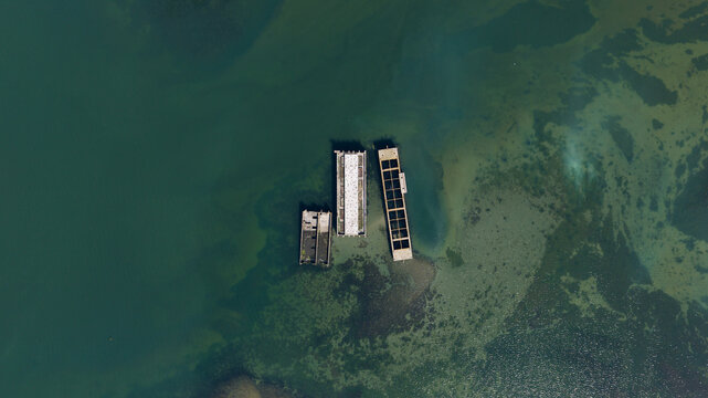 Aerial view of the historic concrete caissons at Inlaag Schelphoek resting in the clear coastal waters of Serooskerke Schouwen, Zeeland, Netherlands.