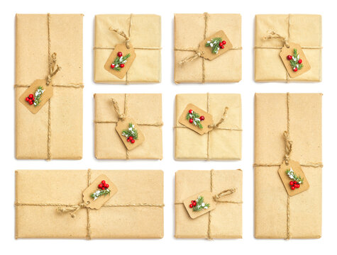 Set of holiday vintage gift packaging from kraft paper with red berries and spruce branches on white isolated background, top view