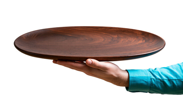 Hand holding an empty round dark brown wooden serving plate or platter