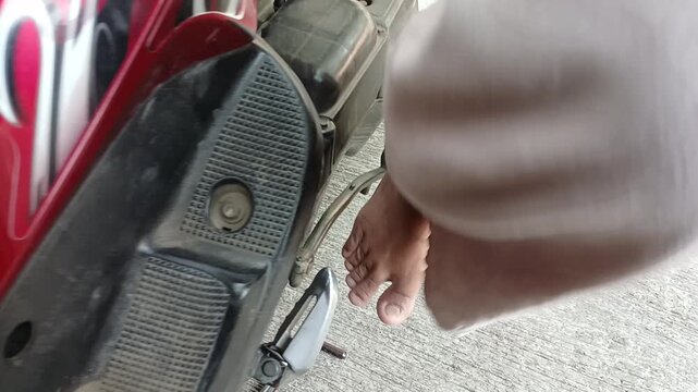 feet starting a motorcycle with kick starter lever 