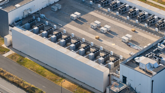 Aerial view of CAMPUS DATA CENTER DATA4 with rows of industrial cooling units on the rooftop in Nozay, Ile-de-France, France.