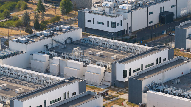 Aerial view of the DATA4 data center campus featuring modern industrial buildings with rooftop cooling systems and HVAC units in Nozay, Ile-de-France, France.