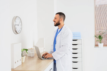 Healthcare burnout and medical shift work, doctor using laptop in hospital office with clock...