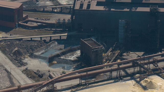 Aerial view of the ArcelorMittal steel plant featuring industrial infrastructure, complex pipe networks, and production facilities in Dunkerque, Hauts-de-France, France.
