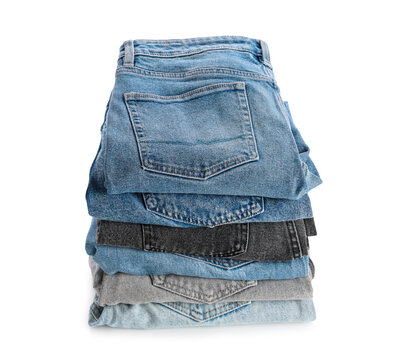 Sustainable fashion and clothing consumption, stack of folded denim jeans in various colors and washes for retail or wardrobe organization