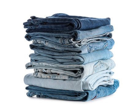 Sustainable fashion and clothing consumption, stack of folded blue denim jeans wardrobe organization and textile recycling on white background
