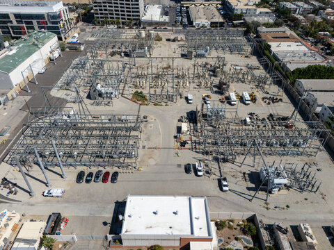 Aerial view of the electrical substation at 936 N Poinsettia Pl featuring metal power structures, transformers, and parked utility vehicles in Los Angeles, California, United States.