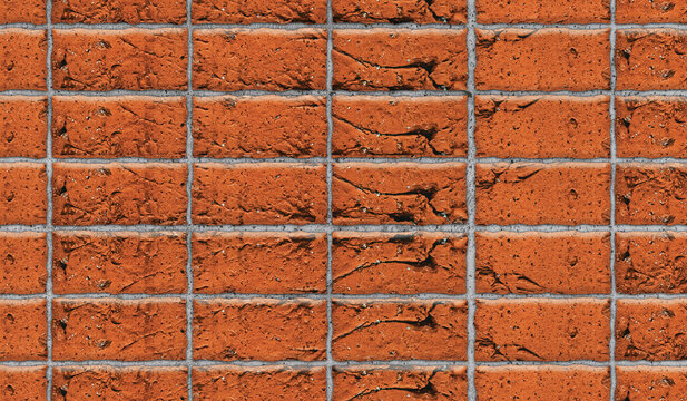 Cracked orange brick wall with gray grout in daylight for construction and renovation backgrounds