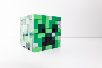 Naklejka premium A green Lego Minecraft creeper head shot isolated on a white background. Bradford, UK Oct 2 2026