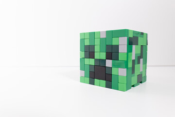 Naklejka premium A green Lego Minecraft creeper head shot isolated on a white background. Bradford, UK Oct 2 2026