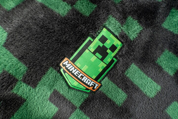 Naklejka premium A Minecraft creeper fabric badge on black and green creeper fleece material. Bradford, UK Oct 2 2026