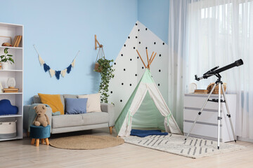 Childhood development and imagination cozy playroom interior with teepee tent telescope and soft furniture for creative learning and play at home © Pixel-Shot