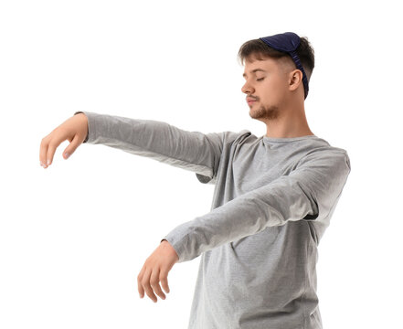 Sleep deprivation and exhaustion, young man sleepwalking with eye mask in pajamas showing fatigue and burnout symptoms isolated on white background