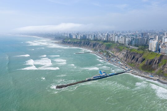 Aerial view of the Rosa Nautica pier and the coastline of Miraflores with the Pacific Ocean and city skyline in Miraflores, Lima Province, Peru.