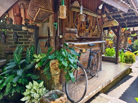 Tabanan, Bali, Indonesia - September 19,2026 :a rustic porch and vintage setup, decorated with traditional artifacts and sepeda onthel