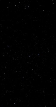 Faint stars glimmer in mysterious cosmic darkness.