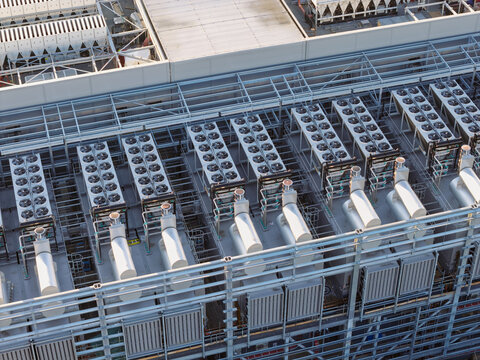 Aerial view of a data center roof featuring rows of industrial cooling fans and HVAC equipment in the United Kingdom.