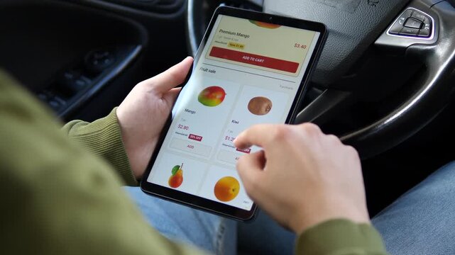 Person shops discounted fruit on a tablet, comparing mango and kiwi prices as digital grocery retail highlights convenience, promotions and price-conscious consumer behavior.