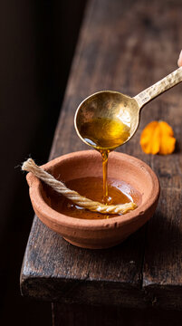 Mustard oil poured into an unlit clay diya before Diwali lighting
