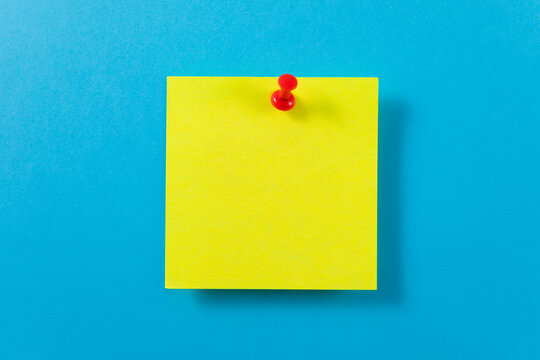yellow sticky note with push pin