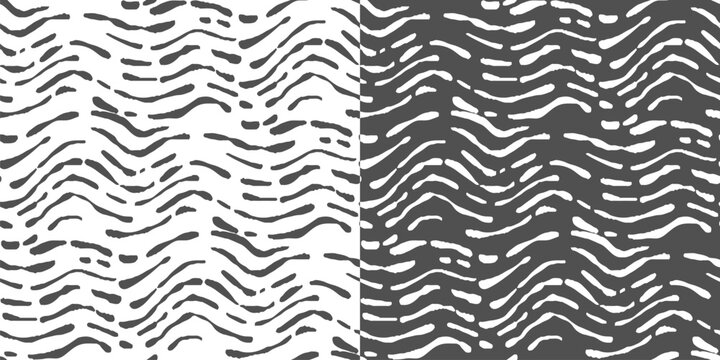 Abstract black and white seamless wave pattern for reversible textile prints on a transparent background.