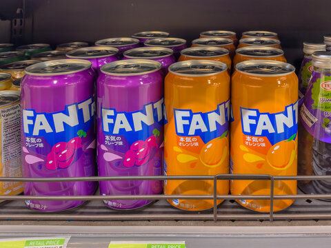 Calgary, AB, Canada. Oct 2, 2026. Colorful cans of Korean Fanta orange and grape soda drinks arranged on a grocery store shelf in a retail cooler.