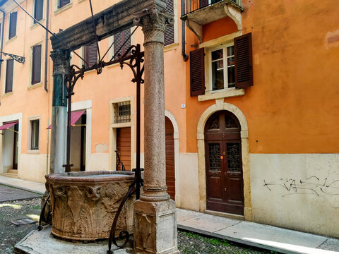 An antique red Verona marble well located in a courtyard near Piazza dei Signori in Verona, Italy