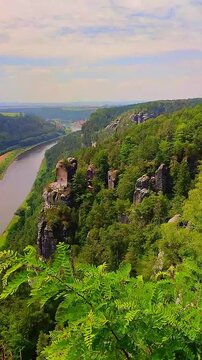 Panning panoramic over birdview over Bastei sandstone rocks near Kurort Rathen village, Elbe river in the national park Saxon Switzerland by Dresden, Saxony, Germany