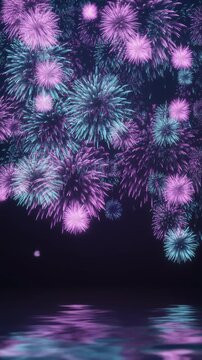 Bright colorful fireworks exploding in the night sky over water surface reflection, vertical 9:16