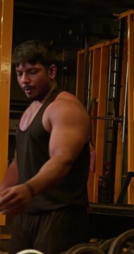 Muscular Bodybuilder Training Triceps With Weights During Gym Workout &mdash; Focused athlete completes multiple triceps repetitions with controlled movements, showcasing defined arms, strength development 