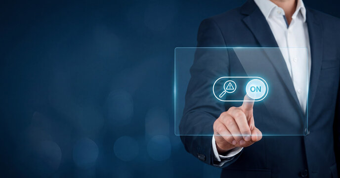 Businessman in modern suit interacting with holographic interface activating security switch button indoors