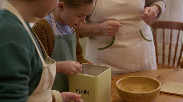 Caucasian senior grandmother and grandchildren playfully putting flour on faces while baking together. Suitable for family lifestyle campaigns, intergenerational bonding, and food marketing