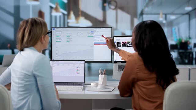 Manager And Assistant Review Online Ad Campaign Analytics.