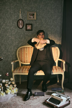 Contemplative figure surrounded by classic items and subdued lighting