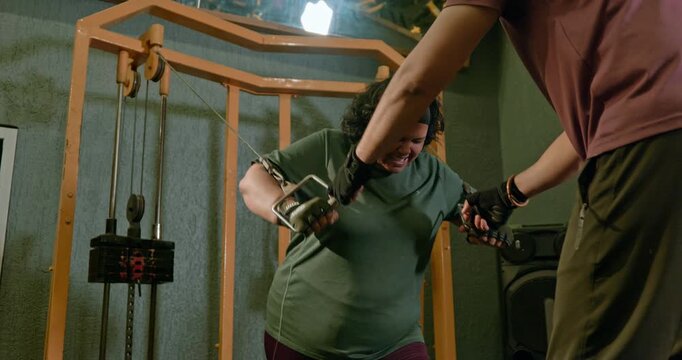 Fitness Athlete Performing Bench Press With Trainer Coaching and Support &mdash; Determined man completes chest workout sets using a bench press and rope exercise while a personal trainer provides guidance 