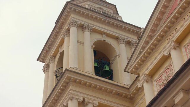 Upward view of historic church bell tower with columns in Imperia, Liguria, Italy