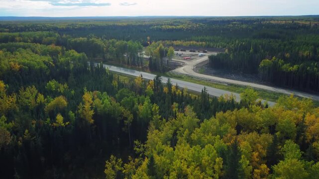 Oilfield lease pad with flare flames in Central Alberta