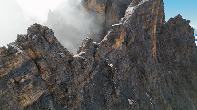 Climber on extreme and difficult Via Ferrata Marino Bianchi, steep rock climb on Monte Cristallo, Dolomites, Italy