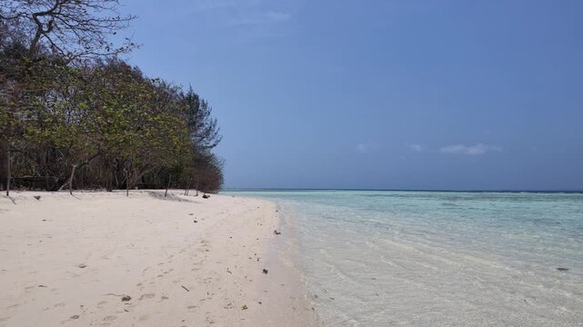 Cemara Kecil island paradise with pristine white sand beach, turquoise tropical waters, and lush coastal foliage, ideal for summer travel and island getaway footage