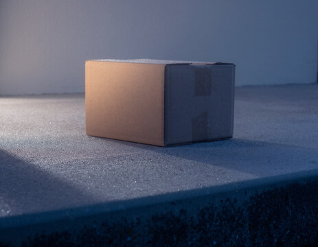 Unlabeled parcel on a dawn doorstep, Black Friday delivery