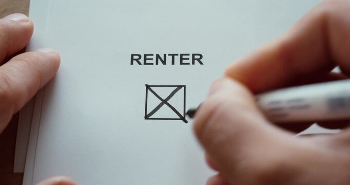 Close-up of a person using a black marker to check a checkbox labeled Renter on a printed paper. Concept of renting, housing, tenancy, property, accommodation and residential status.