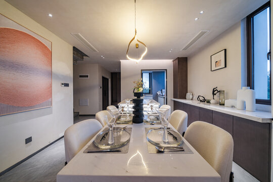 modern minimalist dining room interior table setting with white chairs and pendant lighting