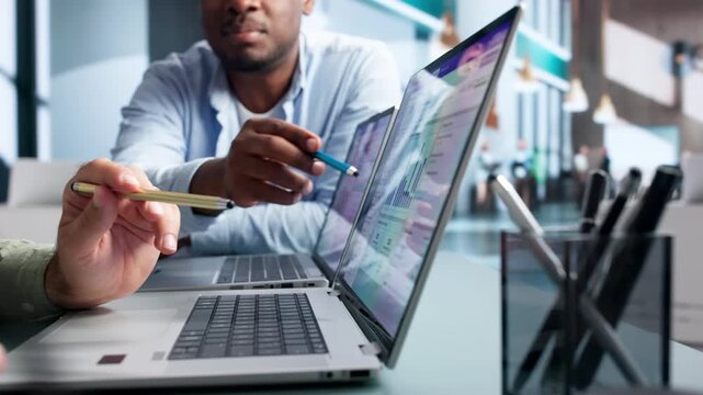 Association Manager Reviews Membership Renewal Data On Laptop